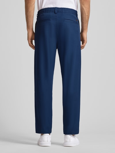 Männermodel trägt Tapered Chino mit Kordelzug Modell 'CHINO ST-P' von BOSS Orange, Optik: Unifarben, Baumwoll-Mix, Ganzkörperansicht Rückansicht.