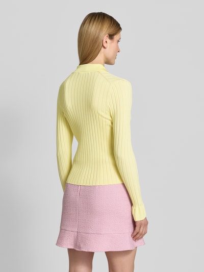 Vrouwenmodel draagt gebreid jack uit viscosemix met platte kraag van Marc Cain, riblook, slim fit, knoopsluiting, ruglengte 54 cm, mouwlengte 65 cm, pastelgeel en lichtroze, dames, volledig silhouet rugaanzicht.
