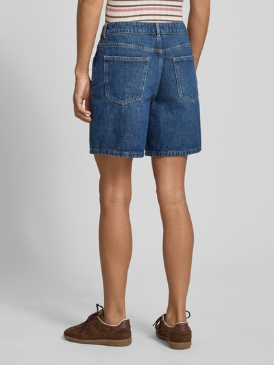 Frauenmodel trägt Jeansshorts mit Eingrifftaschen von REVIEW, Reine Baumwolle, Regular-Fit, blaue Farbe, Ganzkörperansicht Rückansicht.
