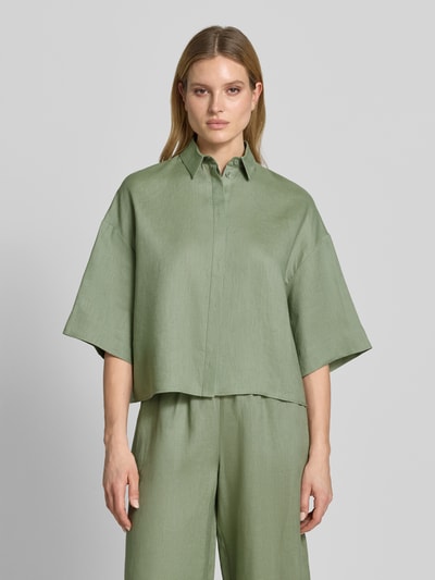 Frauenmodel trägt Boxy Fit Leinenbluse mit 3/4-Arm Modell 'RITO' von MM by Max Mara, reine Leinen, Hemdblusenkragen, verdeckte Knopfleiste, Rückenlänge 58 cm, Ärmellänge 27 cm, Ganzkörperansicht von vorne.