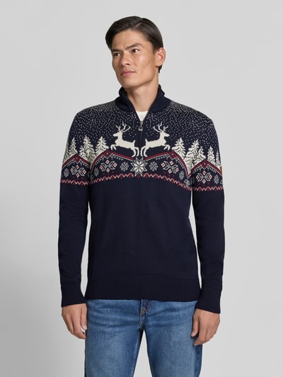 Männermodel trägt Regular Fit Strickpullover aus reiner Wolle Modell 'Dale' von Dale of Norway, Norweger-Muster, Ganzkörperansicht von vorne. Rückenlänge 72 cm, Ärmellänge 68 cm, Troyer-Kragen.