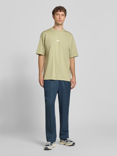 Männermodel trägt Oversized T-Shirts aus reiner Baumwolle Modell 'Nalono' von HUGO, lockeres Design in Beige und Blau, Ganzkörperansicht von vorne, Herren Oversized Shirt von HUGO Blue