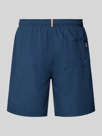 Produktfoto, Badeshorts mit Label-Schriftzug Modell 'ORCA' von BOSS, Optik: Unifarben, Tunnelzug, Bundabschluss: elastisch, seitliche Eingrifftaschen, Gesäßtasche, glatte Struktur, dunkles Blau