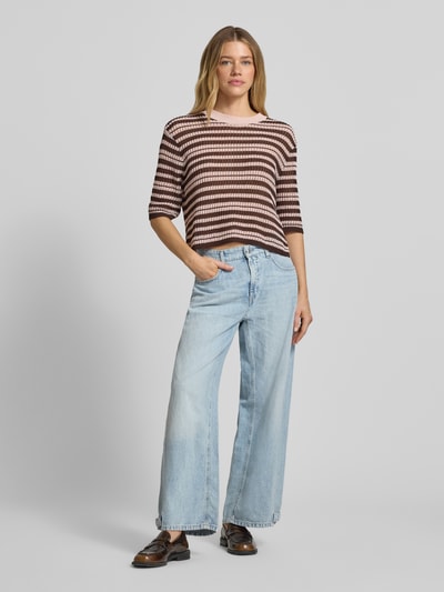 Kobiece model prezentuje Wide Fit Jeans mit Leinen-Anteil Modell 'Oaklyn' von Cambio, mieszanka lnu i bawełny, krój wide fit, 5 kieszeni, zapięcie na guzik i zamek błyskawiczny, szerokość w rozmiarze 36: 40 cm, długość wewnętrzna nogawki w rozmiarze 36: 70 cm, jasnoniebieski denim, widoczne tekstury, całopostaciowy widok z przodu.