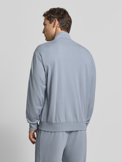 Männermodel trägt hellblaue Regular Fit Sweatjacke aus Viskose-Mix Modell 'SW_Union Tape FZ' von BOSS Green, Ganzkörperansicht Rückansicht.