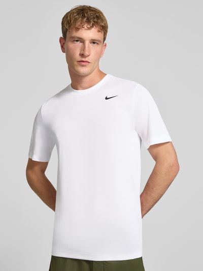 Männermodel trägt T-Shirt mit Logo-Print und Rundhalsausschnitt von NIKE TRAINING, Weiß, glatte Struktur, Regular Fit, Ganzkörperansicht von vorne.