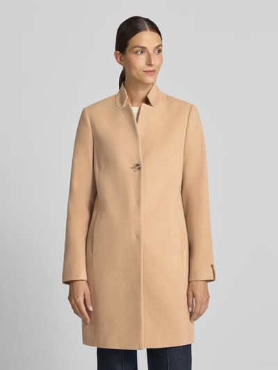 Frauenmodel trägt Mantel mit Viskose-Anteil von COMMA in Beige, glatte Textur, taillierte Passform, Stehkragen, Knopfverschluss, Ganzkörperansicht von vorne. Rückenlänge 90 cm, Schulterbreite 38 cm, Brustweite 47 cm, Ärmellänge 64 cm, elastischer Material-Mix.