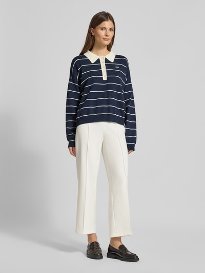 Frauenmodel trägt Straight Fit Stoffhose mit Ziernaht Modell 'Cameron' von Cambio in Offwhite, verkürzte Passform, Ganzkörperansicht von vorne.