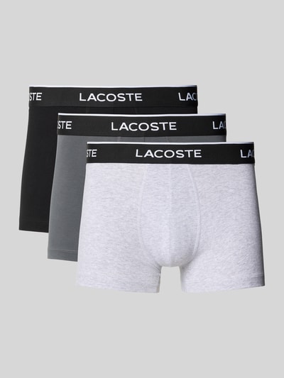 Produktfoto, Trunks Baumwoll-Mix im 3er-Pack von Lacoste, unifarben mit elastischem Label-Bund, glatte Oberfläche, neutrale Farben.