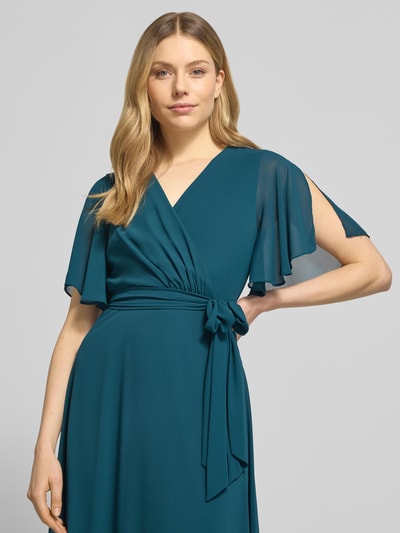 Vrouwenmodel draagt Regular Fit Abendkleid mit V-Ausschnitt van Christian Berg Cocktail, donkergroen, geplooide taillering, korte mouwen, afneembare stoffen ceintuur, ondoorzichtige onderrok, totale voorkantopname, bovenlichaam close-up.