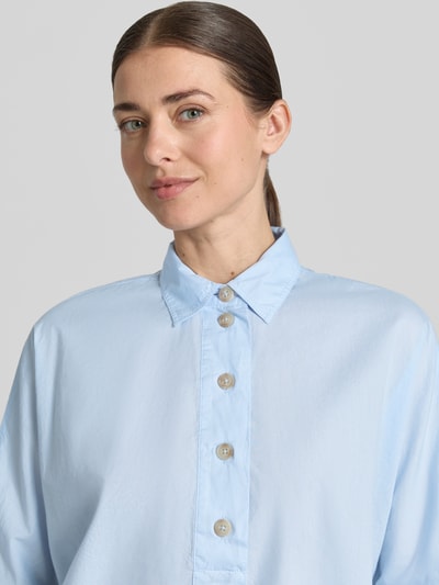Frauenmodel trägt Boxy Fit Bluse mit 3/4-Arm von Emily Van den Bergh aus Reine Baumwolle, Hemdblusenkragen, Knopfleiste, Nahaufnahme Oberkörper.