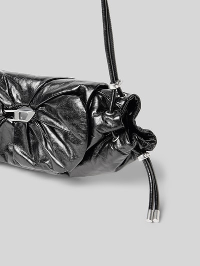 Produktfoto, schwarze Shoulder Bag mit Logo-Detail von Diesel mit Raffungen, glänzende Textur, Magnetverschluss, Nahaufnahme Seitendetail