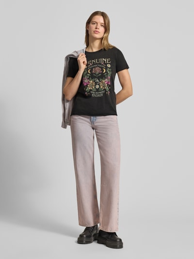 Kobiece modelka nosi Damski t-shirt Regular Fit T-Shirt aus reiner Baumwolle Modell 'LUCY' od ONLY, efekt: jednolity kolor, nadruk z motywem, okrągły dekolt, krótki rękaw ze zrolowanym brzegiem, wykończenie: zrolowany brzeg, dżersej, bawełna, całkowity widok z przodu.