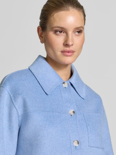 Frauenmodel trägt Jacke mit aufgesetzten Taschen Modell 'Helia' von OPUS in Hellblau, Baumwoll-Mix mit Viskose, Nahaufnahme Oberkörper.