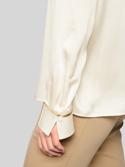 Vrouwenmodel draagt Regular Fit zijden blouse met contraststrepen van Marc Cain, zuiver zijde, knoopsluiting, detailopname mouw.