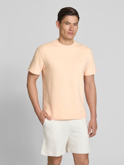 Männermodel trägt Regular Fit T-Shirt aus reiner Baumwolle von Lacoste, Optik: Unifarben, Label-Patch, Rundhals, Feinstrick, Ganzkörperansicht von vorne.