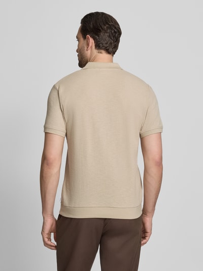 Męski model nosi Comfort Fit Poloshirt mit V-Ausschnitt von Lindbergh z bawełny, fakturowany wzór, detal z logo, długość tyłu 68 cm, rozmiar M, całkowity widok z tyłu