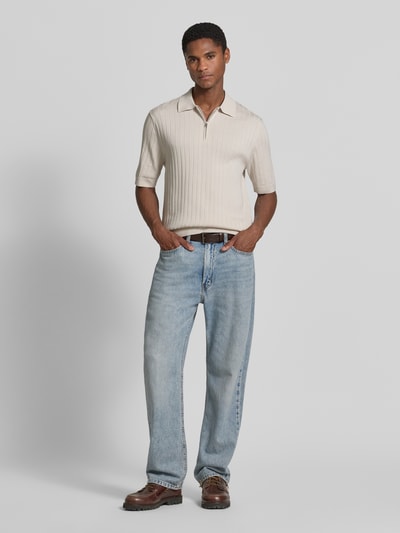 Männermodel trägt Regular Fit Poloshirt mit kurzem Reißverschluss von Drykorn in Beige, Reine Baumwolle, Polokragen, Ganzkörperansicht von vorne. Modell 'NIIVAN', Rückenlänge bei Größe M: 68 cm