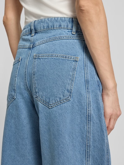 Frauenmodel trägt Barrel Fit Jeans mit Eingrifftaschen Modell 'Alannah' von Neo Noir, reine Baumwolle, hellblau, Detailaufnahme Rückenansicht.