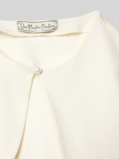 Produktfoto, cremefarbener Bolero mit Knopfverschluss von Une Hautre Couture, Rundhalsausschnitt, glatte Struktur, Detailaufnahme