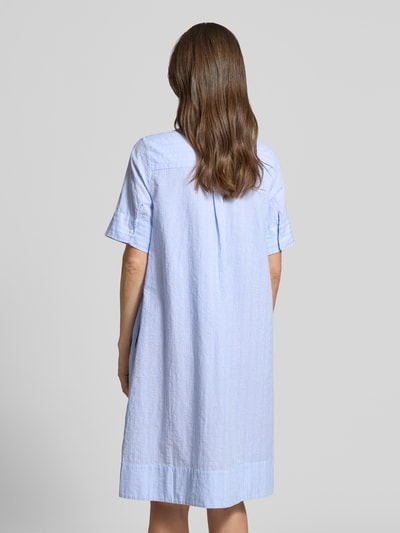 Frauenmodel trägt Knielanges Hemdblusenkleid mit Motiv-Print von Milano Italy aus Reine Baumwolle, Gerader-Schnitt, Knielänge, 1/2-Arm, Knopfleiste, hellblau mit dezentem Print-Motiv, leichte Struktur, Rückenlänge 100 cm, Brustweite 52 cm, Ärmellänge 28 cm, Ganzkörperansicht Rückansicht.