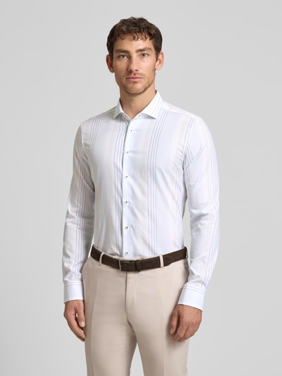 Männermodel trägt Slim Fit Business-Hemd aus Baumwolle mit Haifischkragen von ETERNA, feine Streifen, Knopfleiste, Ganzkörperansicht von vorne, Rückenlänge bei Größe 40 80 cm, Schulterbreite 45 cm, Ärmellänge 67 cm, Reine Baumwolle.