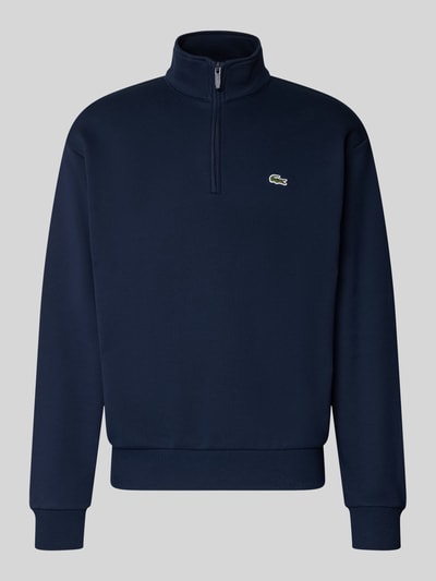 Produktfoto, Regular Fit Troyer aus Baumwoll-Mix von Lacoste in Dunkelblau mit Reißverschluss und strukturierter Oberfläche vor grauem Hintergrund