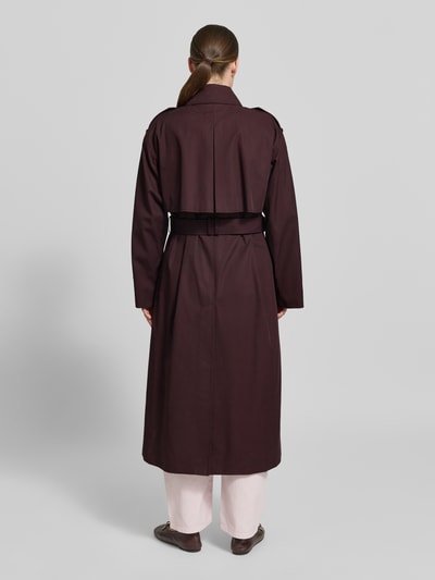 Kobiece modelka nosi Oversized Trenchcoat aus reiner Baumwolle od Tommy Hilfiger, efekt: jednolity kolor, krój oversized, wykładany kołnierz, listwa guzikowa 2-rzędowa, pasek w talii, aplikacja: gun flap, pagony, kontrafałda, rozporek, długi rękaw, patki przy mankietach, hydrofobowy, wpuszczane kieszenie, materiał: bawełna; widok całej sylwetki od tyłu.
