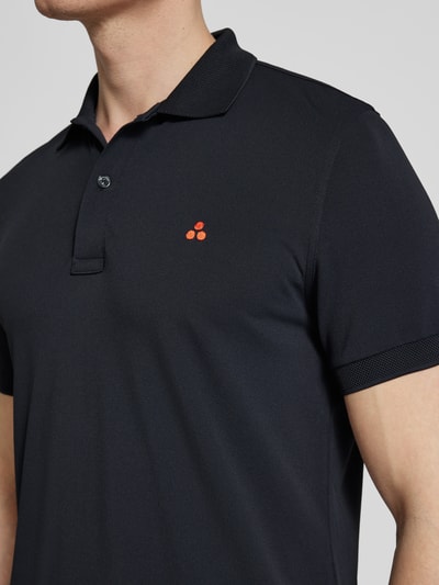 Mężczyzna nosi Regular Fit Koszulka polo z haftem model 'PLANTAGO' od Peuterey, mieszanka materiałów z dodatkiem streczu, kołnierzyk polo, listwa guzikowa, długość tyłu w rozmiarze M: 71 cm, kolor czarny, gładka faktura, haftowane logo z przodu, krótki rękaw. Zbliżenie na górną część ciała.