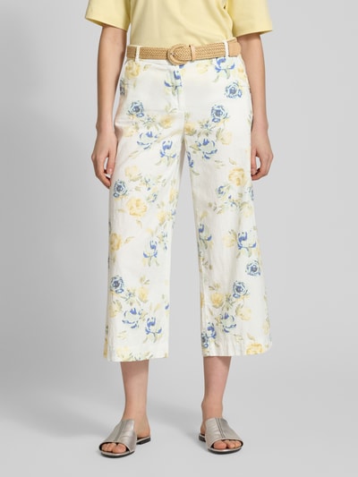Frauenmodel trägt Caprihose aus Leinen-Baumwoll-Mix mit Gürtel von Christian Berg Woman, florales Muster in Gelb und Blau, verkürzte Passform, Allover-Look, Nahaufnahme Unterkörper, Vorderansicht.