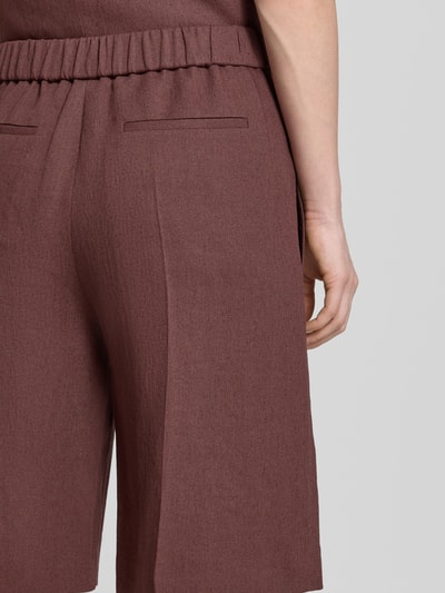 Vrouwenmodel draagt Regular Fit Bermudas uit mix van linnen en viscose model 'TIANALA' van BOSS, mêlee look, twill, detailopname rug
