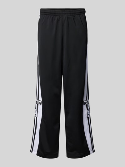 Produktfoto, Trainingshose mit Label-Details und elastischem Bund von adidas Originals in Schwarz-Weiß, Relaxed Fit, Modell 'ADIBREAK', Innenbeinlänge 75 cm in Größe M, strukturierte Oberfläche.