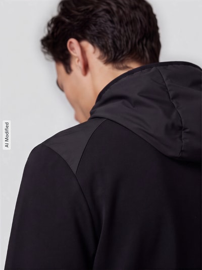 Männermodel trägt schwarze Regular Fit Sweatjacke aus Baumwoll-Mix Modell 'PUMATECH' von PUMA, Herren Sweatjacke, Rückansicht, KI-modifiziertes Bild.
