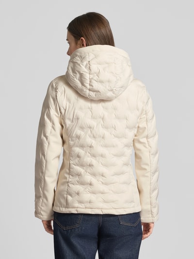 Frauenmodel trägt Regular Fit Steppjacke mit Kapuze von s.Oliver RED LABEL, unifarben creme, elastische Ärmel, Ganzkörperansicht Rückansicht.