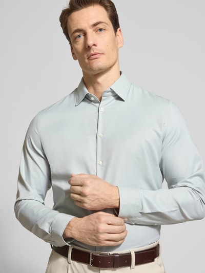 Männermodel trägt Slim Fit Business-Hemd mit Kentkragen von Jake*s, Material-Mix mit Stretch-Anteil, hell, Knopfleiste, Nahaufnahme Oberkörper.