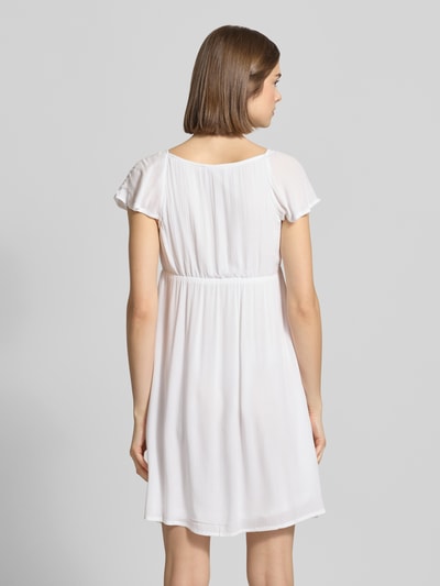 Frauenmodel trägt Babydoll Kleid aus Reine Viskose mit Karree-Ausschnitt und Schleife von REVIEW, Gerader-Schnitt, Minikleid, Rückansicht Ganzkörperansicht.