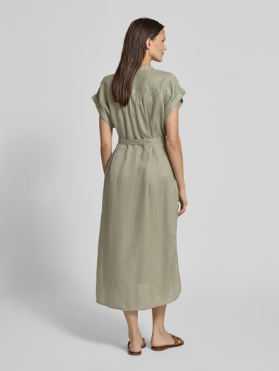 Frauenmodel trägt Hemdblusenkleid aus Leinen mit Bindegürtel Modell 'AMATISTA' von ECOALF, Midikleid in hellem Grün, Rückansicht, Ganzkörperansicht.