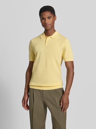 Męski model nosi Slim Fit Poloshirt mit kurzer Knopfleiste Modell 'TRITON' von Drykorn, bawełna, kolor żółty, krój slim fit, widok z przodu, całe ciało.