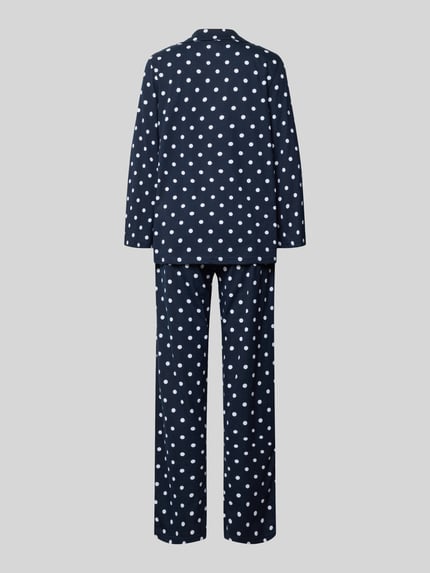 Frauenmodel trägt Pyjama im Allover-Look von LOUIS & LOUISA, navy mit weißen Punkten, reine Baumwolle, Ganzkörperansicht Rückansicht.