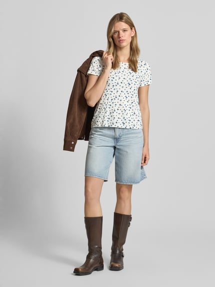 Frauenmodel trägt Regular Fit T-Shirt aus Viskose-Mix Modell 'BERA' von Only mit Allover-Muster, U-Boot-Ausschnitt, kurzarm, Ganzkörperansicht von vorne.