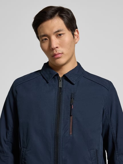Männermodel trägt Regular Fit Hemdjacke aus reiner Baumwolle von Tom Tailor in Dunkelblau, sichtbarer Reißverschluss, Nahaufnahme Oberkörper.