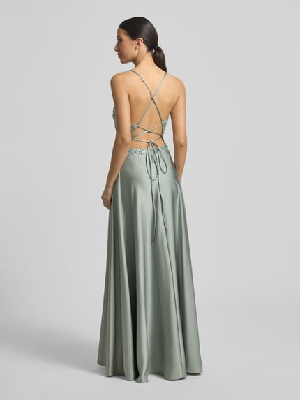 Vrouwenmodel draagt 'Abendkleid mit Perlen und V-Ausschnitt' van Laona, jurk van satijn in groen met parels, taillered maxi-jurk, ruglengte 144 cm, borstwijdte 30 cm, maxirok, detailopname rugaanzicht.