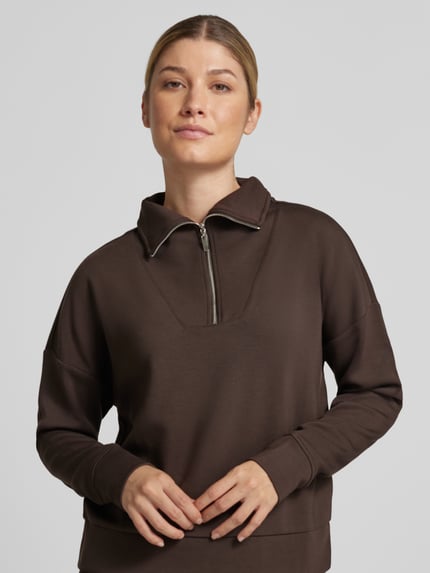 Frauenmodel trägt Troyer mit Stehkragen und Reißverschluss von Christian Berg Woman, braun, Material-Mix mit Modal-Anteil, Regular Fit, Nahaufnahme Oberkörper.