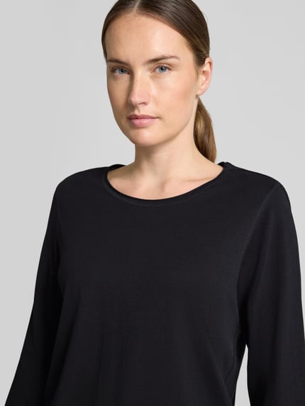 Vrouwenmodel draagt Regular Fit 3/4-shirt uit puur katoen van s.Oliver RED LABEL, effen zwart, zachte textuur, close-up bovenlichaam.