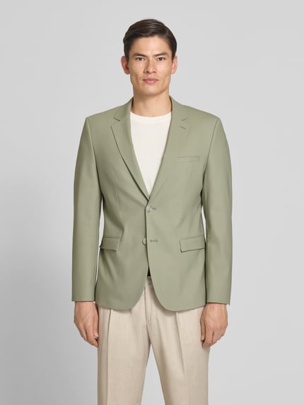 Męski model nosi Super Slim Fit Anzugsakko aus Woll-Mix Modell 'ARTI' von HUGO, efekt: jednolity kolor, model, kołnierz z połami, listwa z 2 guzikami, długi rękaw, zakończenie rękawów nachodzące na siebie guziki, podwójne wykończenie, kieszenie z patką, brustasza, kieszeń wewnętrzna, wykończenie materiału: popelina, mieszanka wełny; Ganzkörperansicht von vorne.