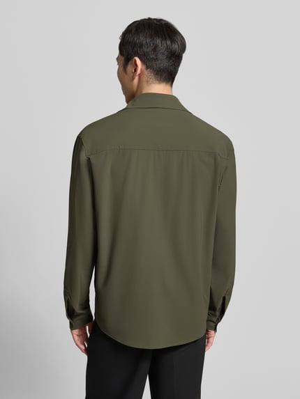 Männermodel trägt Hemdjacke mit knoopsluiting van CRUNA in olijfgroen, materiaalmix met stretch, regular fit, kentkraag, borstzakken met knoopsluiting, ruglengte bij maat 50: 77 cm, geheel van achteren bekeken, Ganzkörperansicht Rückansicht.