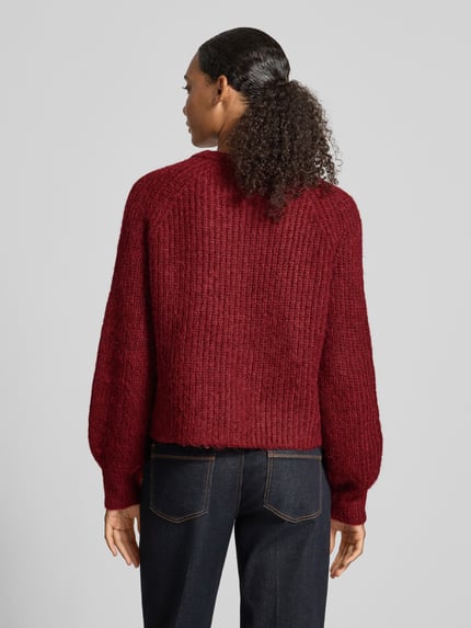 Frauenmodel trägt Regular Fit Cardigan in Strick-Optik von Christian Berg Woman Selection in dunkelrot, weiche Textur, Ganzkörperansicht Rückansicht. Rückenlänge bei Größe S 53 cm, Ärmel 69 cm, Rundhalsausschnitt und durchgehende Knopfleiste.
