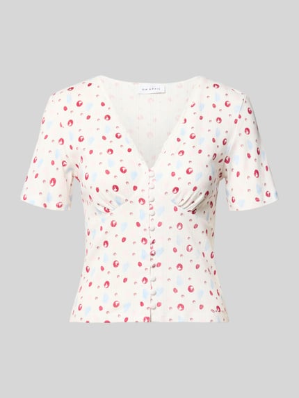 Produktfoto, Blusenshirt in Pointelle-Optik Modell 'Vianne' von OH APRIL aus Reine Baumwolle im eng anliegenden Schnitt mit V-Ausschnitt, Spitzenbesatz, Knopfleiste, Rückenlänge 33 cm bei Größe S, helle Grundfarbe mit zarten Punkten, dezente Struktur.