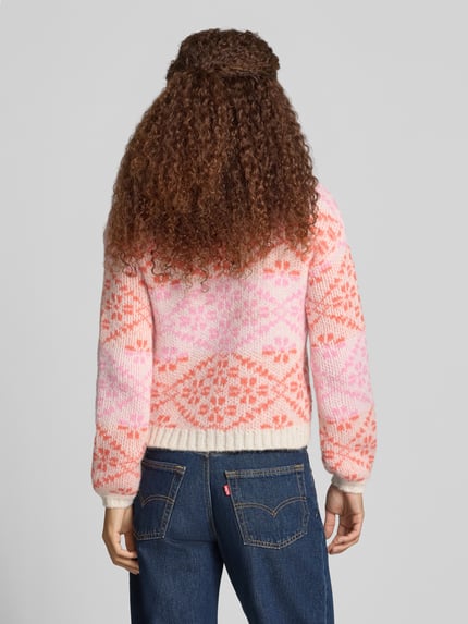 Frauenmodel trägt Pullover mit Jacquardstruktur Modell 'ONLCARO' von ONLY, mehrfarbig, geometrisches Allover-Muster, Strickoptik, Ganzkörperansicht Rückansicht.