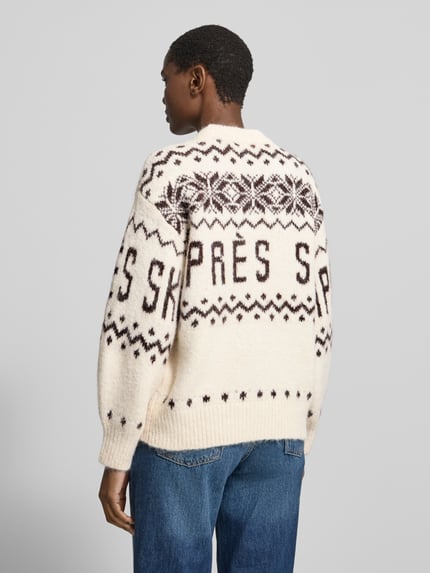 Männermodel trägt Pullover mit Ballonärmeln von VERO MODA in Strickoptik mit geometrischem Allover-Muster, creme mit braun, Ganzkörperansicht Rückansicht.